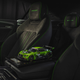 a photo of the black and green interior of the limited edition Bentley with a model car on the seat.